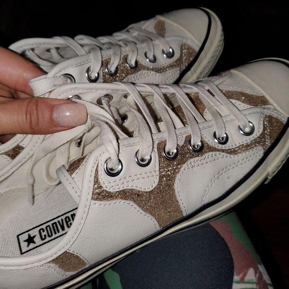 white and gold leather converse